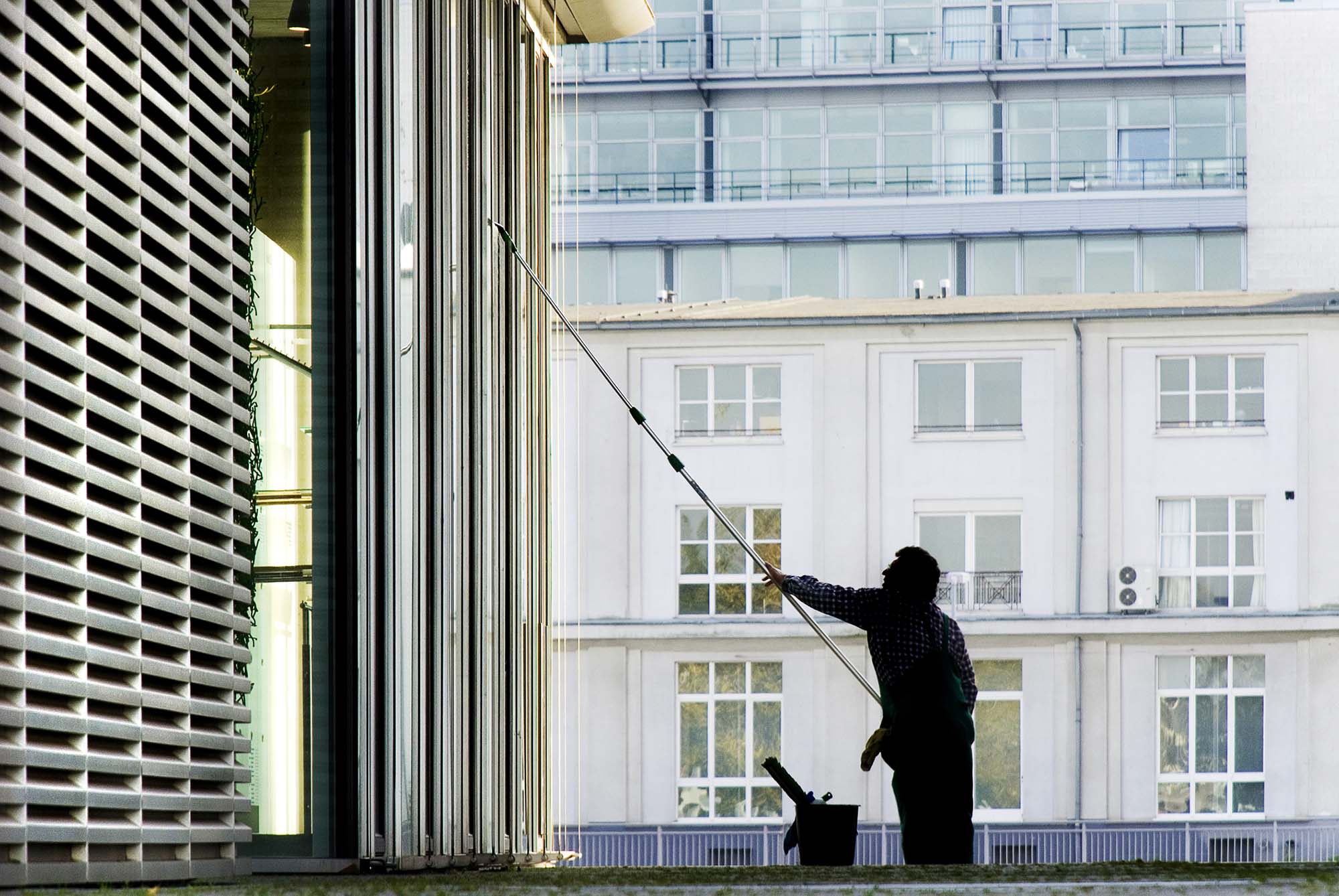 Window-cleaner in a city at the work