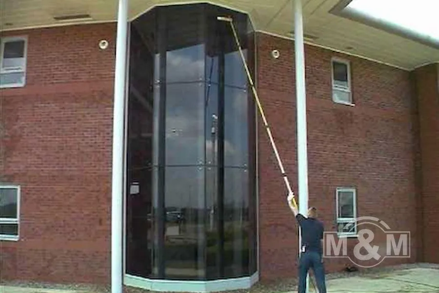 Window cleaner cleaning hexagonal windows in offices